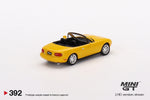 Mini GT 1:64 MiJo Exclusives Mazda Miata MX-5 (NA) Sunburst Yellow - Unrivaled USA