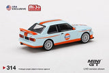 Mini GT 1:64 MiJo Exclusives World Wide BMW M3 E30 with Gulf Livery Limited Edition - Unrivaled USA